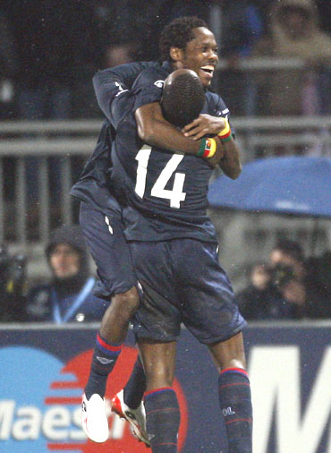 Olympique Lyon's Jean Makoun (left) celebrates with team-mate Sidney Govou after scoring against Real Madrid