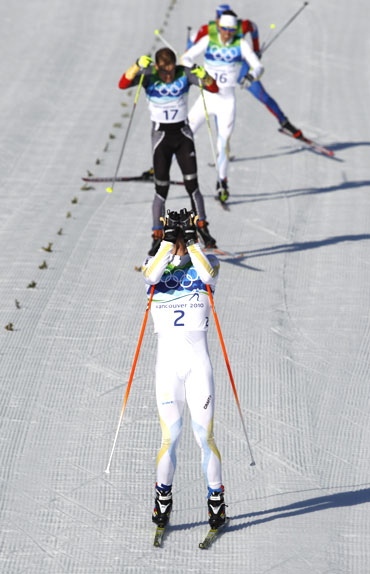 Sweden's Marcus Hellner gets emotional after crossing the finish line of the men's 30 km pursuit cross-country final