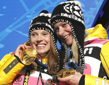 Evi Sachenbacher Stehle and Claudia Kuenzel of Germany pose with their medals during the medal ceremony