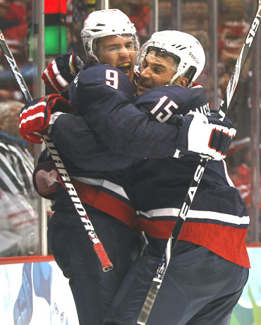 Zach Parise (left) of the US celebrates his goal with Jamie Langenbrunner during their ice-hockey quarter-finals against Switzerland