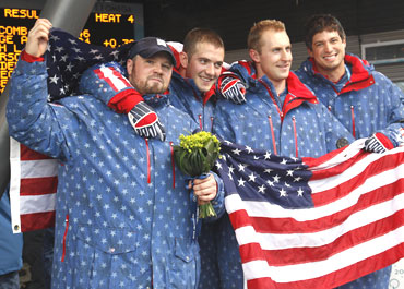 American four-man bobsleigh team's Steven Holcomb, Justin Olsen, Steve Mesler and Curtis Tomasevicz celebrate after winning the gold