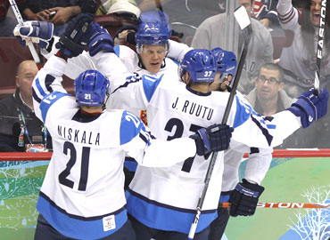 Finland's Olli Jokinen (centre) celebrates with his team-mates after scoring against Slovakia