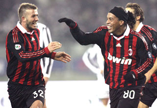 AC Milan's Ronaldinho (right) celebrates with team-mate David Beckham after scoring against Juventus on Sunday