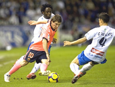 Barcelona's Lionel Messi (centre) is challenged by Tenerife's Carlos Bellvis (right) and Kome during their La Liga tie on Sunday