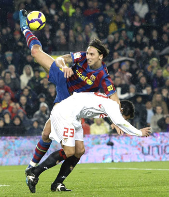 Barcelona's Zlatan Ibrahimovic (left) challenges Sevilla's Lolo