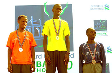 Denis Ndiso is flanked by 1st runners up Siraj Gena (left) and third place holder Samson Limareng