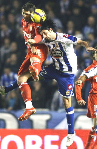 Deportivo Coruna's Juan Rodriguez (right) is involved in an aerial challenge with Sevilla's Ivica Dragutinovic on Wednesday