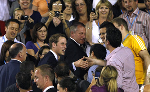 Britain's Prince William greets a spectator at the Rod Laver Arena after during a match between Roger Federer and Victor Hanescu on Thursday