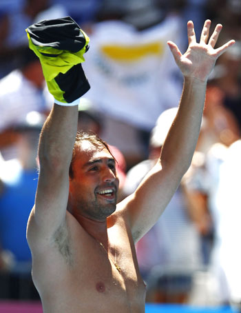 Cyprus's Marcos Baghdatis celebrates his five-set win over Spain's David Ferrer