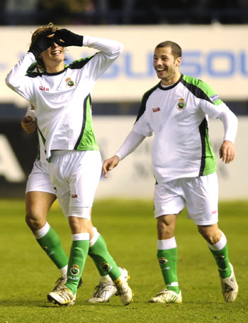 Racing Santander's Sergio Canales (left) and Mehdi Lacen celebrate a goal against Osasuna on Wednesday