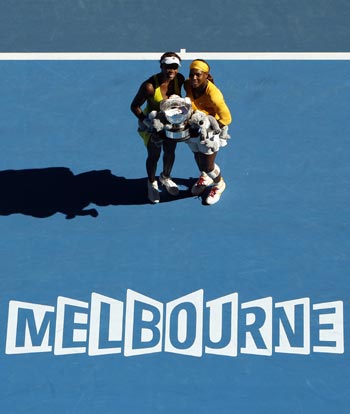Venus (left) and Serena Williams with the Australian Open women's doubles title
