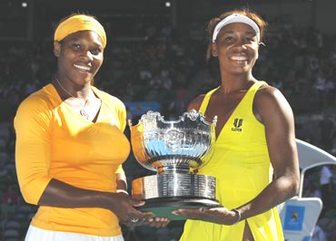 Serena and Venus Williams with the women's doubles trophy
