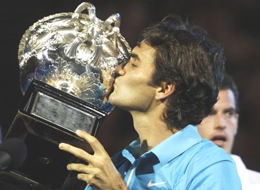 Roger Federer kisses the winners trophy