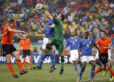 -Brazil's Felipe Melo (C) jumps with team mate goalkeeper Julio Cesar during their 2010 World Cup quarter-final soccer match against Netherlands