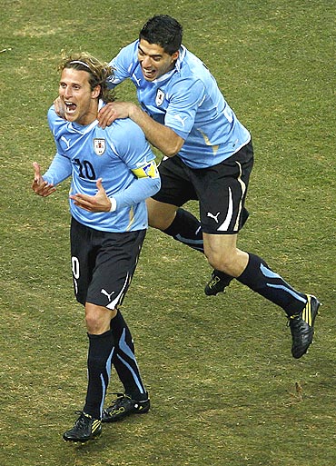Uruguay's Diego Forlan (left) celebrates his goal with teammate Luis Suarez