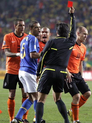 Referee Yuichi Nishimura flashes the red card to Brazil's Felipe Melo for his foul on Arjen Robben