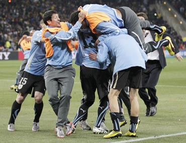 Uruguay team celebrate after making it to the semi-finals