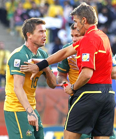 Australia's Harry Kewell (centre) reacts to being shown the red card by referee Roberto Rosetti during a match against Ghana