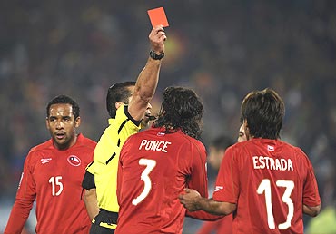 Mexican referee Marco Rodriguez shows the red card to Chile's Marco Estrada (13)