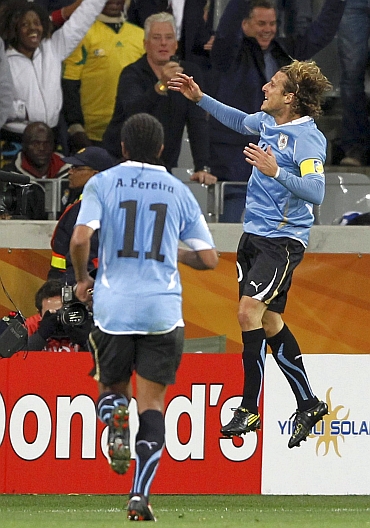 Diego Forlan celebrates after scoring