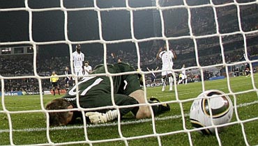 England's Robert Green is distraught after fumbling the ball and letting it past the goalline in their game against the US