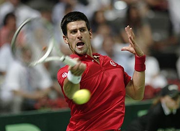 Novak Djokovic returns to Ivan Ljubicic during his Davis Cup doubles tennis match against Croatia