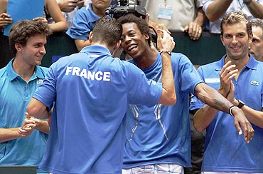 Michael Llodra of France celebrates with Gael Monfils after winning against Fernando Verdasco of Spain