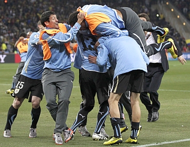 Uruguay players celebrate after winning a match