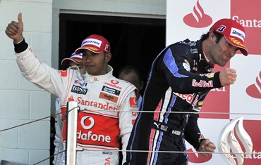Webber (R) and McLaren driver Lewis Hamilton celebrates on the podium