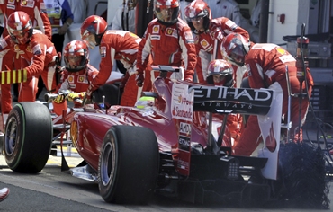 Ferrari Formula One driver Massa of Brazil has a puncture changed during