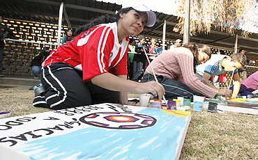 Participants paint at a workshop to promote the Football for Hope programme at the Queen's High School in Johannesburg