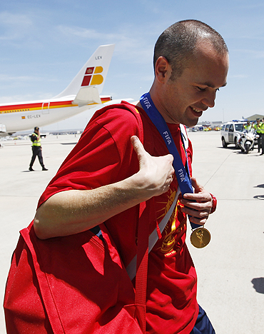 Spain's soccer player Andres Iniesta arrives at Madrid's Barajas airport