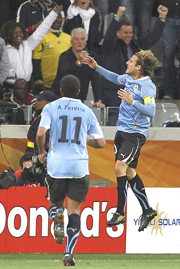 Diego Forlan celebrates after scoring against the Dutch