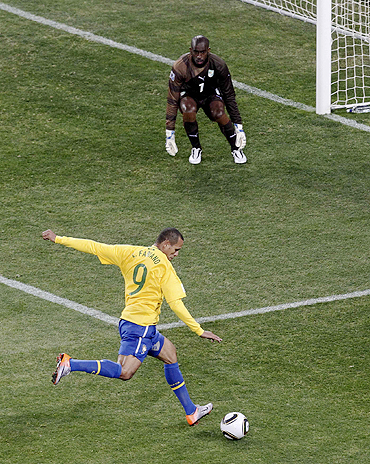 Brazil's Luis Fabiano scores past Ivory Coast's goalkeeper Boubacar Barry