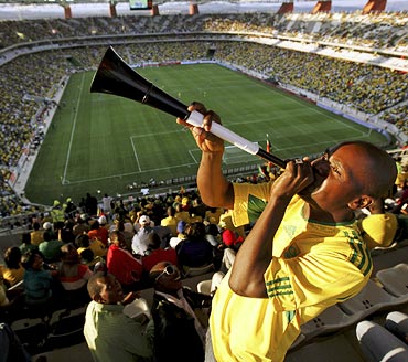 A South African fan blows the vuvuzela