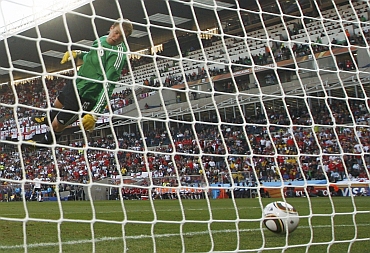 Germany's goalkeeper Manuel Neuer watches as the ball crosses the line during their match against England