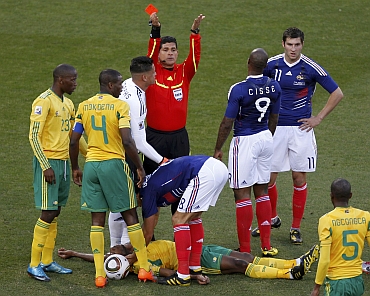 Referee Ruiz gestures after showing the red card to France's Gourcuff for a foul on South Africa's Sibaya
