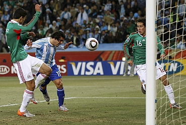 Carlos Tevez scores in a match against Mexico
