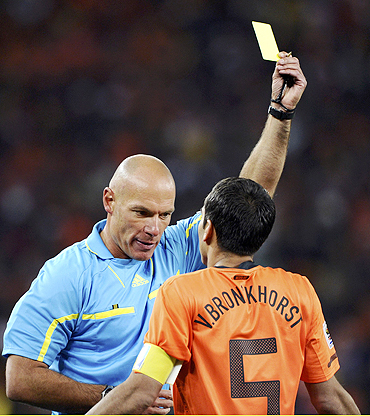 Dutch captain Giovanni van Bronckhorst is shown the yellow card by referee Howard Webb