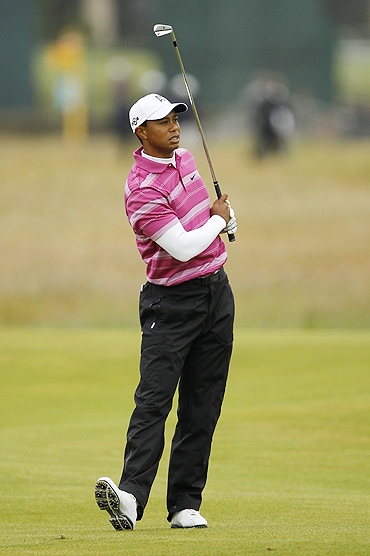Tiger Woods watches his approach shot to the second green during first round of play at the British Open golf championship St Andrews, Scotland, on Thursday