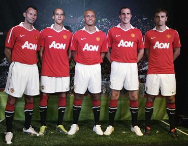 Manchester United players wear the new team jersey during its debut in Chicago
