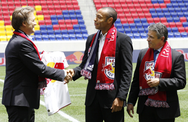 France striker Thierry Henry (centre) shakes hands with head of Red Bulls Global Soccer Dietmar Beiersdorfer in Harrison