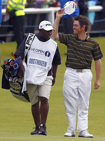 Louis Oosthuizen celebrates with his caddie Zack Rasego after winning the British Open