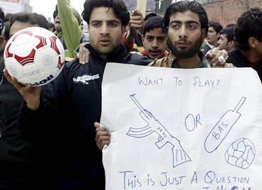 Football players protest against the government's plans to convert a playground into a flower garden in Srinagar