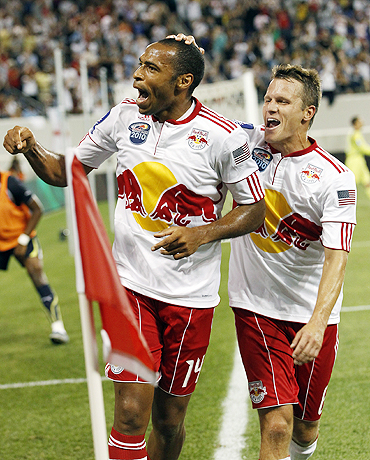 New York Red Bulls' Thierry Henry celebrates with team-mate after he scoring against Spurs