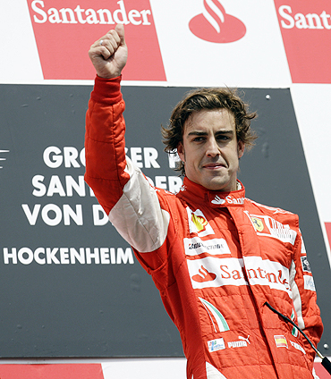 Fernando Alonso on the podium after winning the German GP on Sunday