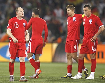England players wear a dejected look after being knocked-out by Germany