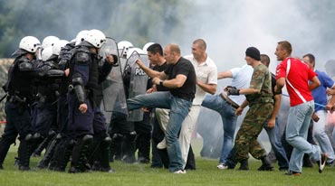 Hooligans clash with police during a match