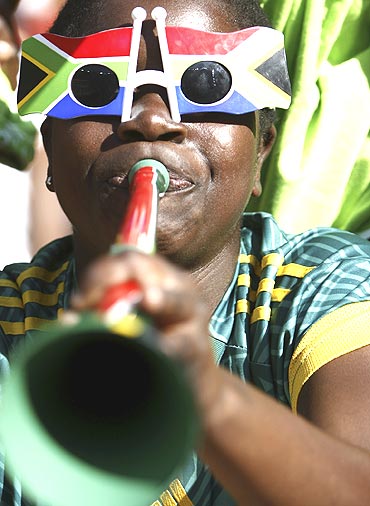 A soccer fan blows a vuvuzela