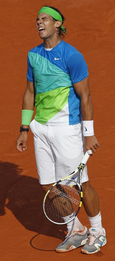 Nadal reacts after losing a point